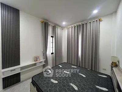 Modern bedroom with stylish curtains and elegant decor in a contemporary home.