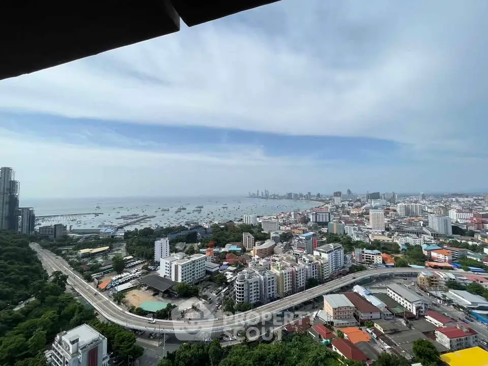 Stunning high-rise cityscape view with ocean horizon and urban skyline.