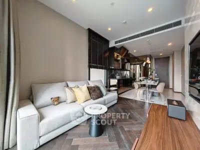 Luxurious modern living room with elegant decor and open kitchen layout.
