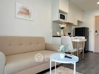 Modern living room with cozy beige sofa and compact kitchen area