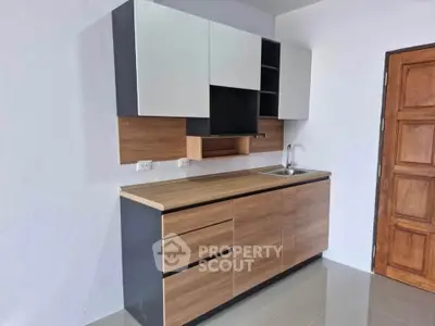 Modern minimalist kitchen with sleek cabinetry and compact design