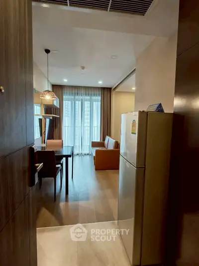 Modern apartment interior with open living and dining area, featuring stylish furniture and natural light.