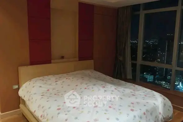 Spacious bedroom with city view in modern high-rise apartment