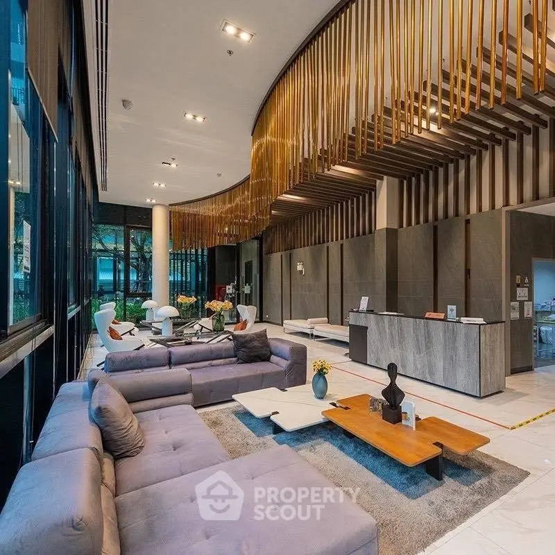 Luxurious modern lobby with elegant seating and stylish decor in a high-end residential building.