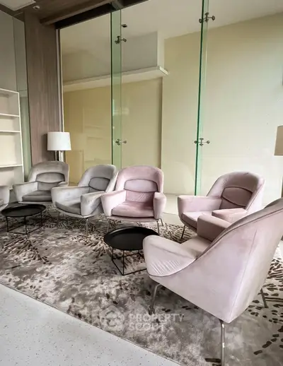 Elegant modern living room with plush armchairs and glass partitions