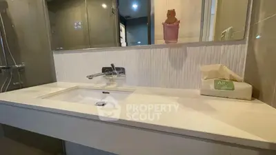 Modern bathroom with sleek sink and stylish fixtures in contemporary apartment.