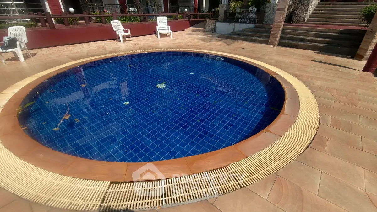 Stunning circular pool with elegant tile surround in a luxurious outdoor setting.