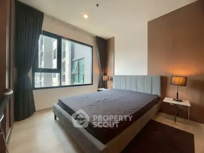 Modern bedroom with large window and stylish decor in urban apartment