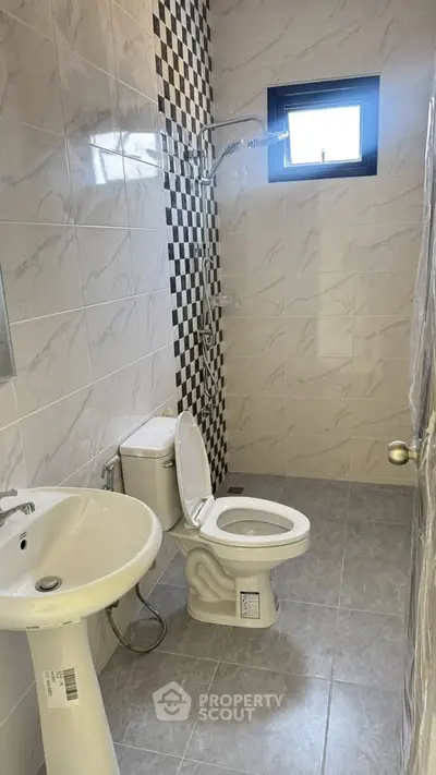 Modern bathroom with stylish tile design and natural light