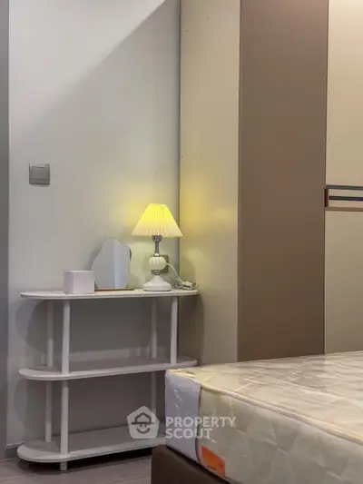 Cozy bedroom corner with stylish lamp and modern decor