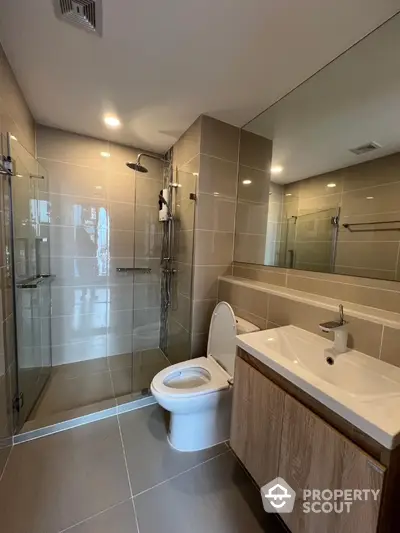 Modern bathroom with sleek design, glass shower, and contemporary fixtures.