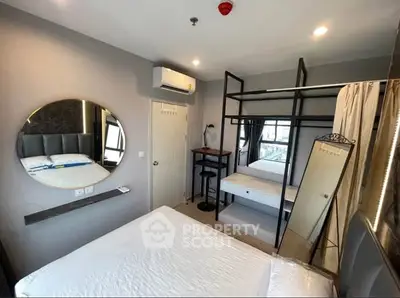 Modern bedroom with bunk bed and stylish decor, ideal for compact living spaces.