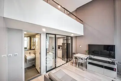 Modern living room with open kitchen and mezzanine in stylish apartment