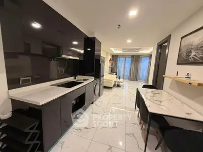 Modern open-layout kitchen and living room with sleek black cabinetry and marble flooring.