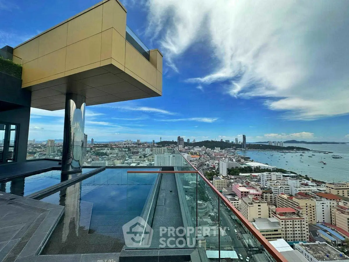 Stunning rooftop view with infinity pool overlooking city skyline and ocean