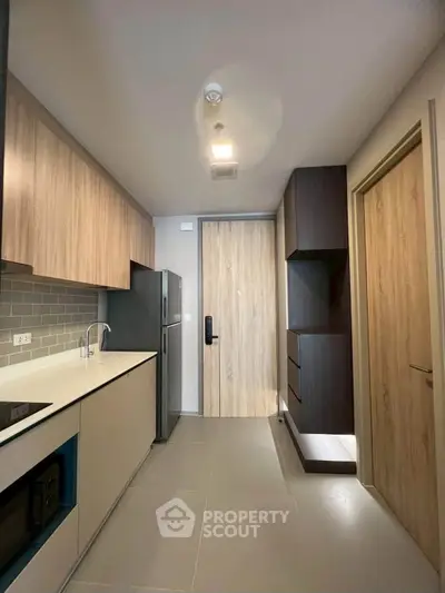 Modern kitchen with sleek cabinetry and built-in appliances in a contemporary apartment.