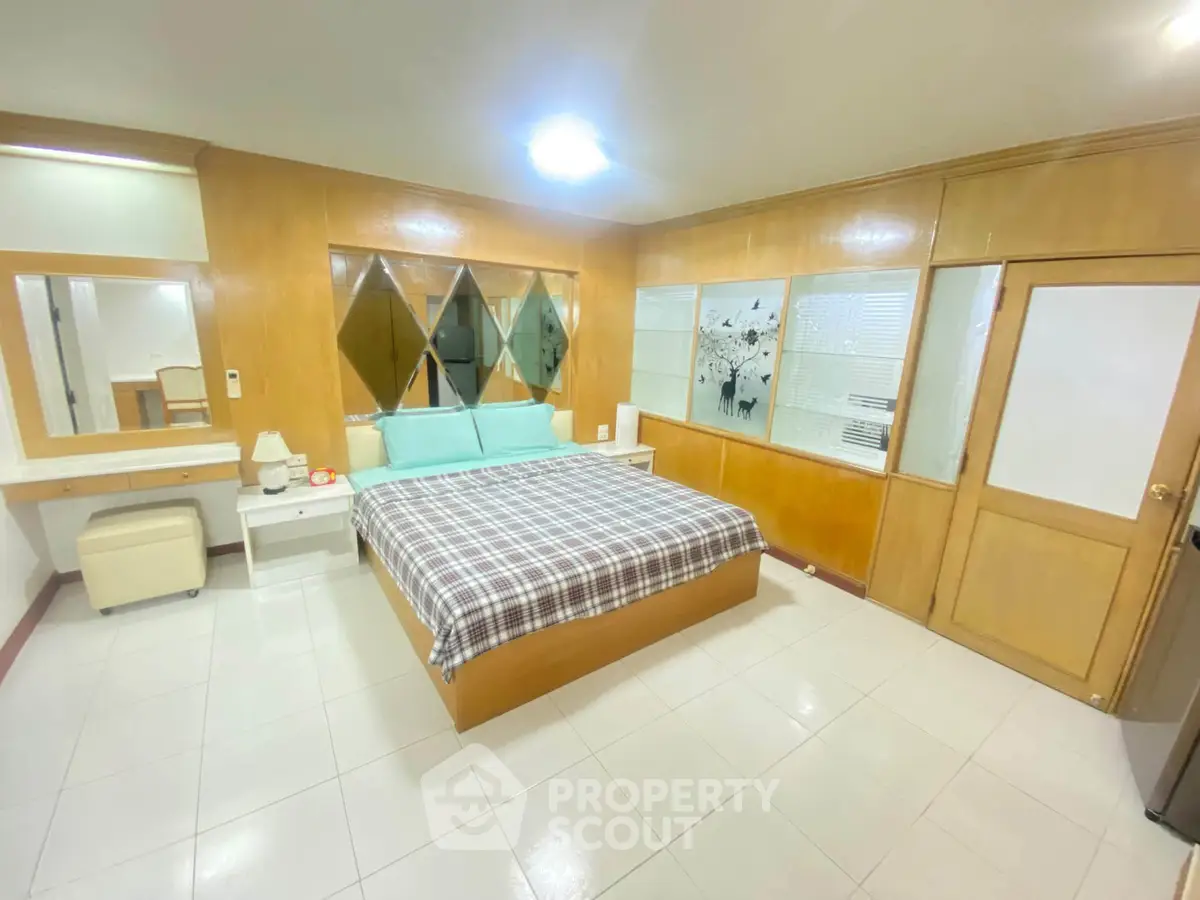 Spacious bedroom with modern decor and ample natural light