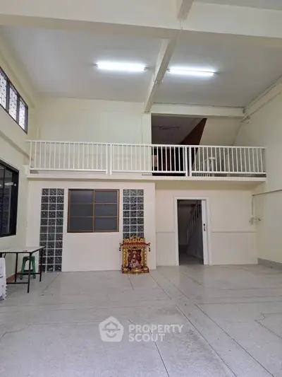 Spacious interior with mezzanine and modern lighting, ideal for versatile use.