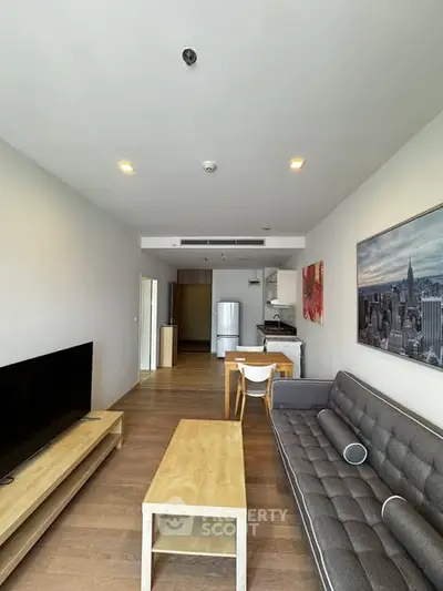 Modern living room with sleek furniture and open kitchen layout