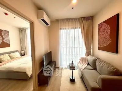 Modern living room with cozy sofa and bedroom view, perfect for urban living.