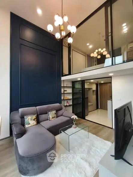 Modern duplex living room with elegant chandelier and cozy seating area