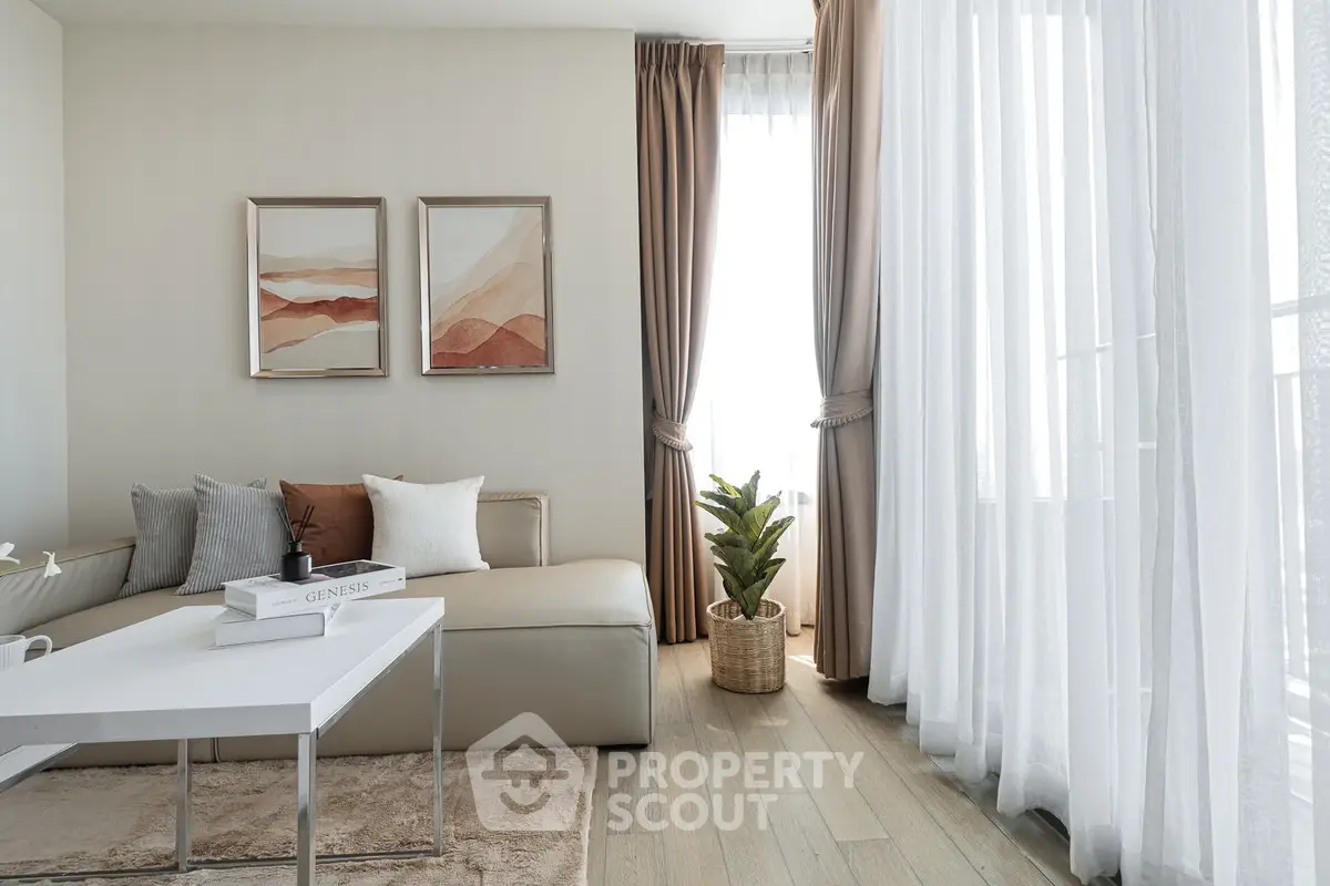 Elegant living room with modern decor, large windows, and cozy seating area.