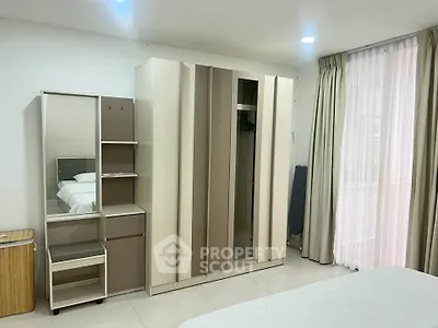 Spacious bedroom with modern wardrobe and natural light