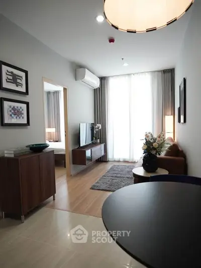 Modern living room with stylish decor and natural light in a contemporary apartment.