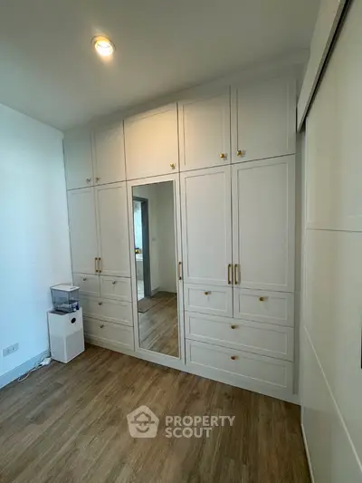 Spacious bedroom with elegant built-in wardrobe and mirrored door