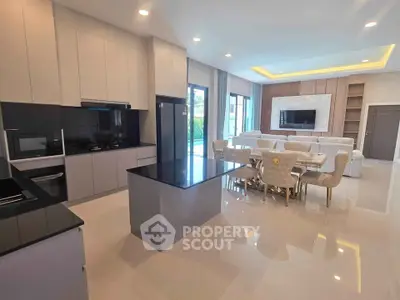 Luxurious open-plan kitchen and living room with modern furnishings and sleek design.