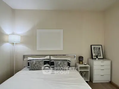 Cozy bedroom with modern decor and stylish lighting, perfect for relaxation and comfort.