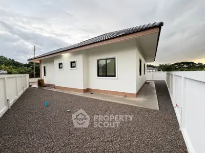 Modern single-story house with sleek design and spacious outdoor area