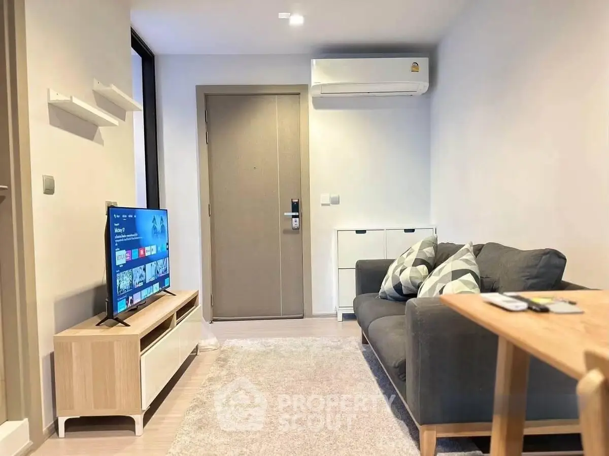 Modern living room with sleek furniture and wall-mounted TV, perfect for cozy relaxation.
