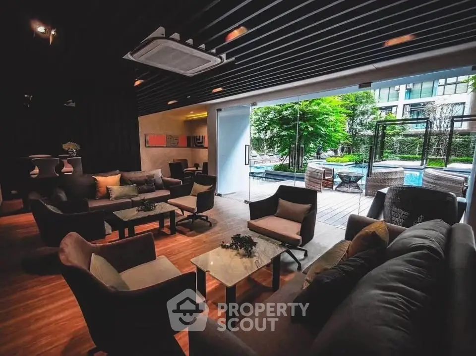 Luxurious modern living room with pool view and stylish furniture, perfect for relaxation and entertaining.