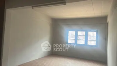 Spacious empty room with natural light and tiled flooring, ideal for customization.