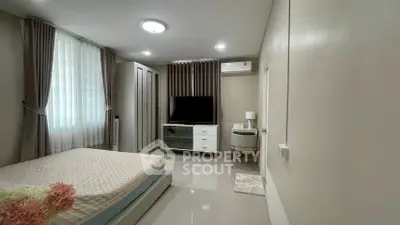 Spacious bedroom with modern decor and ample natural light