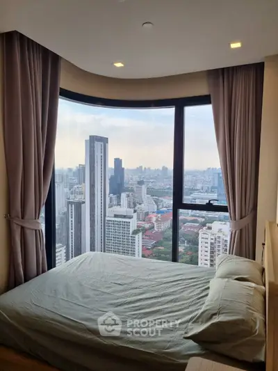 Stunning bedroom with panoramic city view from high-rise apartment