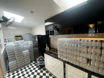 Spacious kitchen with black and white checkered floor, ample storage, and modern appliances.