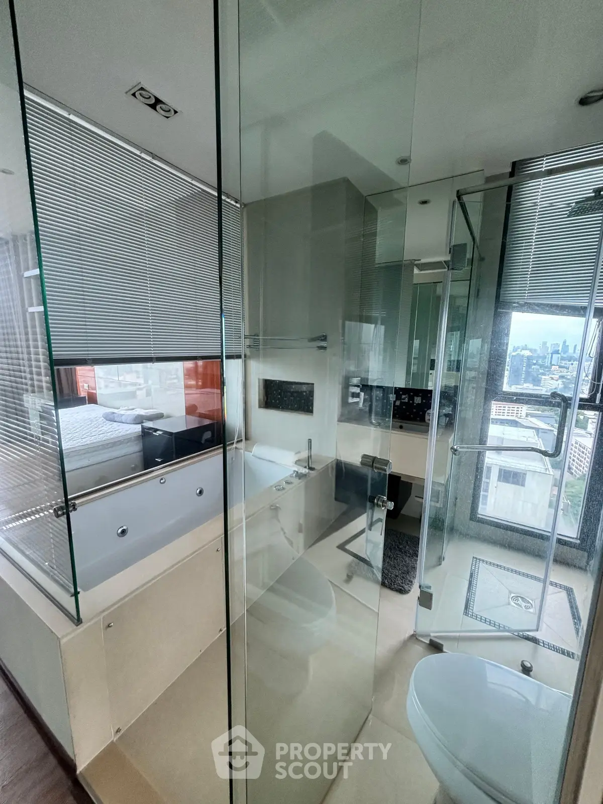 Luxurious bathroom with glass walls and city view, featuring a modern bathtub and sleek design.