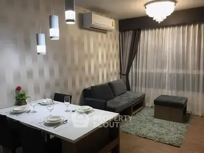 Modern living room with elegant dining area and stylish lighting in a cozy apartment.