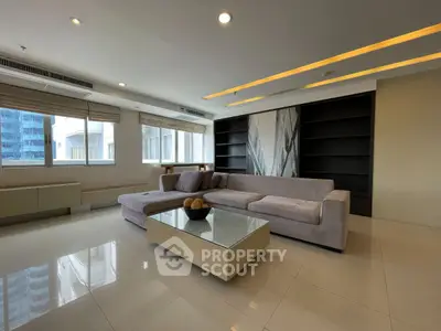 Spacious modern living room with sleek design and large windows offering natural light.