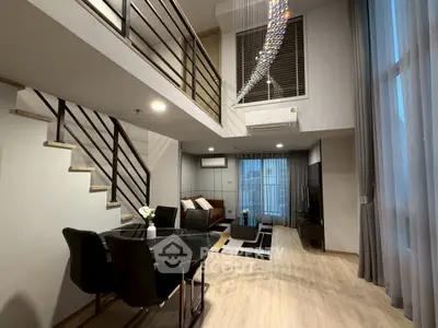 Luxurious modern living room with high ceilings and elegant decor in a duplex apartment.
