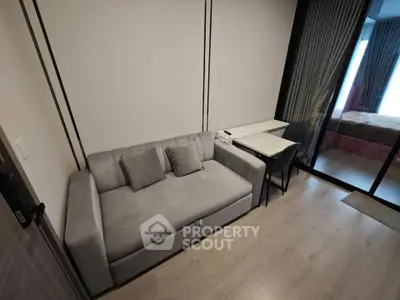 Modern living room with sleek sofa and stylish decor in a contemporary apartment.