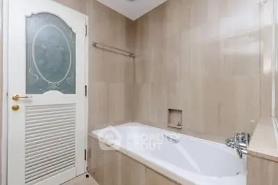 Elegant bathroom with luxurious bathtub and stylish door design