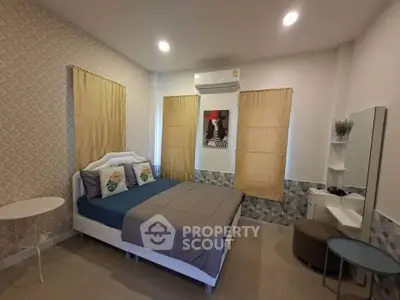 Cozy bedroom with modern decor, featuring a comfortable bed, stylish wallpaper, and ample natural light.