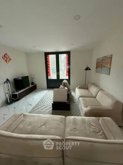 Spacious living room with modern furniture and natural light
