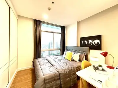 Bright modern bedroom with city view, cozy bed, and stylish decor.