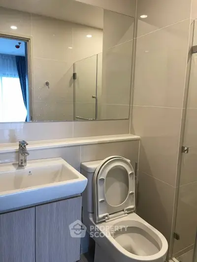 Modern bathroom with sleek fixtures and glass shower enclosure