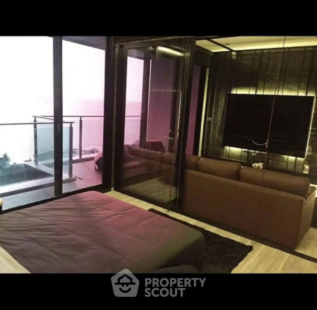 Luxurious modern living room with floor-to-ceiling windows and stunning balcony view.