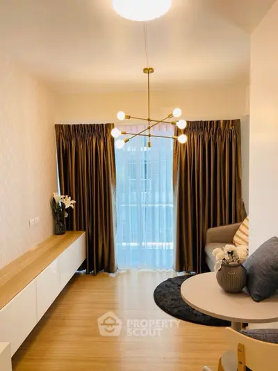 Stylish modern living room with elegant lighting and floor-to-ceiling curtains.